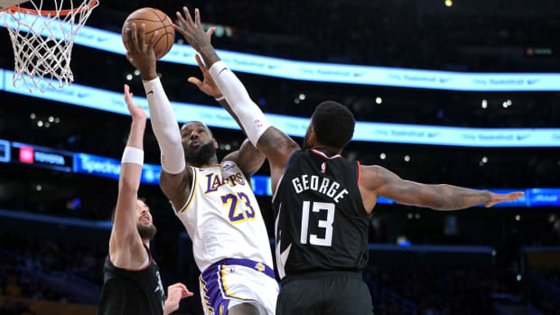 LeBron James shooting over Paul George.